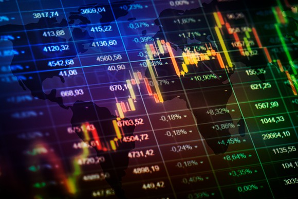 A stock chart laid atop of various numbers