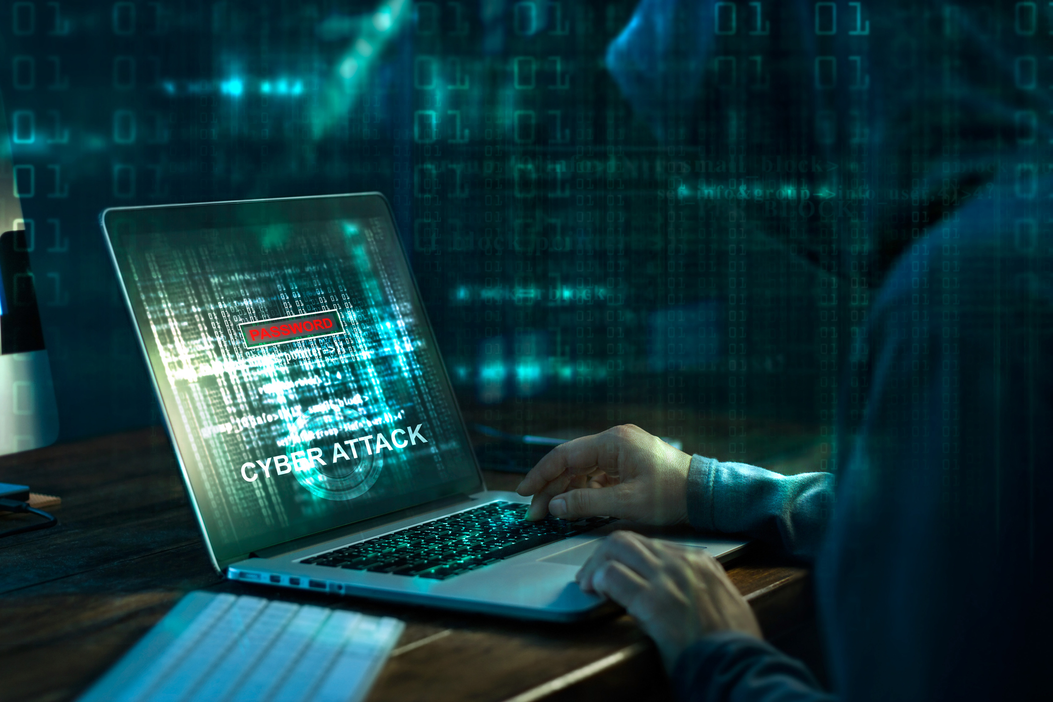 A hooded hacker mounts a cyber attack.
