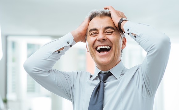 Man in a shirt and tie, laughing