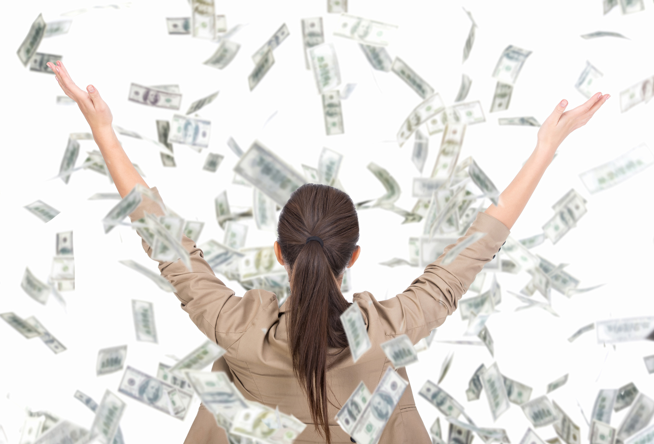 Back of a woman with her hands up in the air while bills rain down on her.