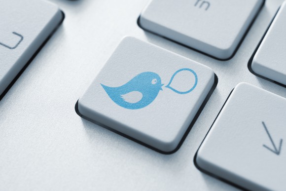 A computer keyboard key with a cartoon bird and a speech bubble