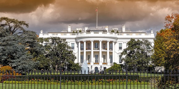 The White House under a cloudy sky.