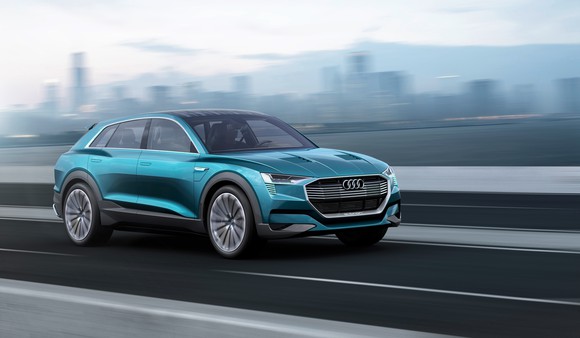 Audi's e-tron quattro concept SUV is shown on a desert landscape.