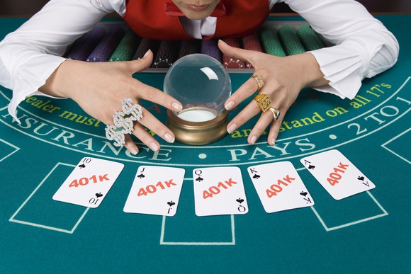 Fortune teller with crystal ball and playing cards labeled 401k.