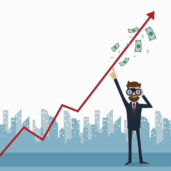 Man pointing at stock chart going up.