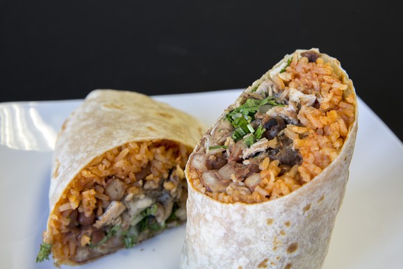 A burrito cut in half on a plate.