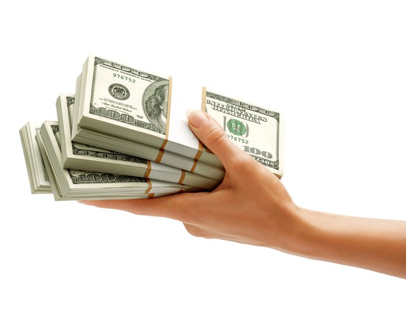 Getty Handed Stack Of Money