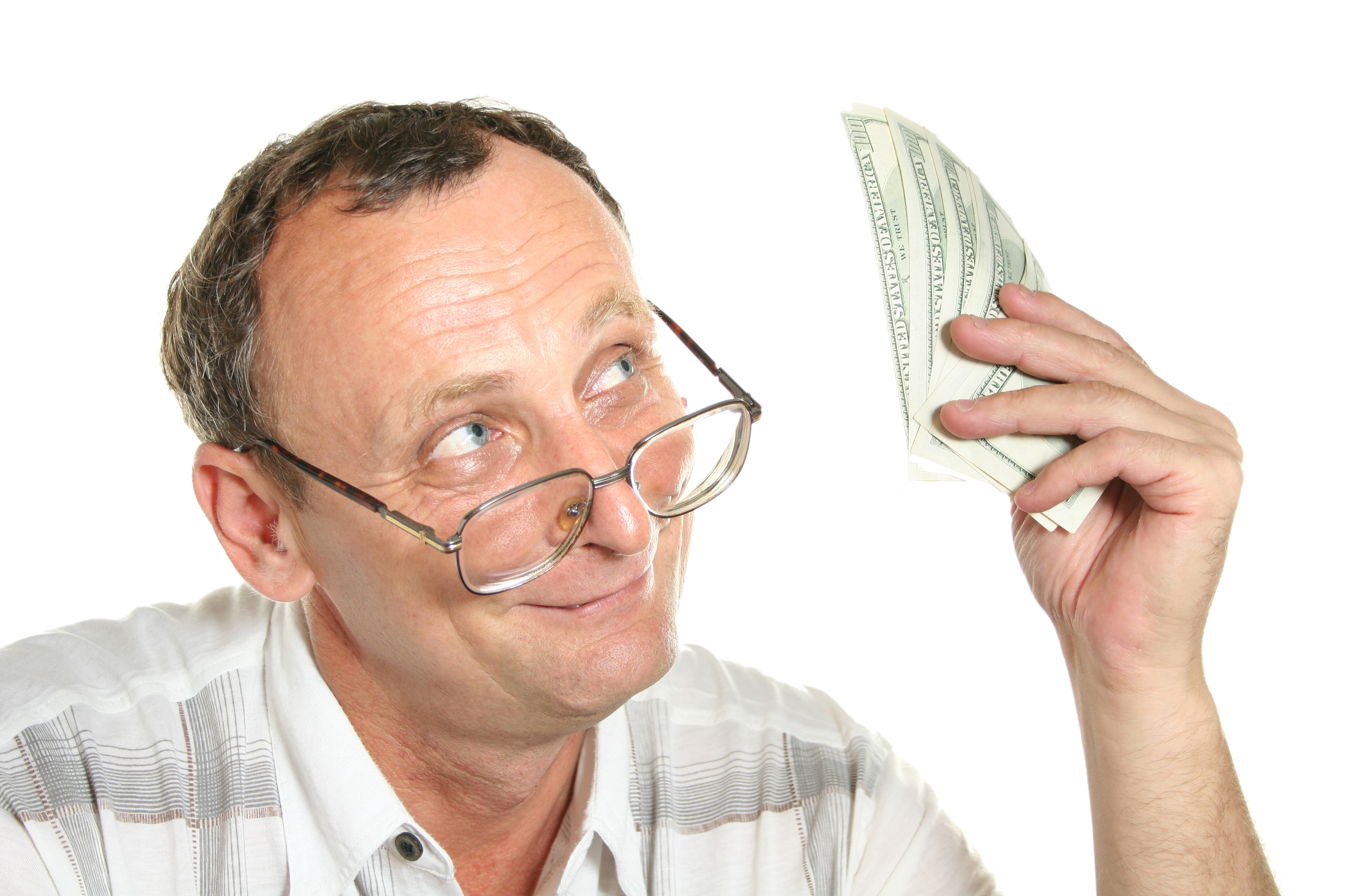 An older man staring at cash held in his hand.