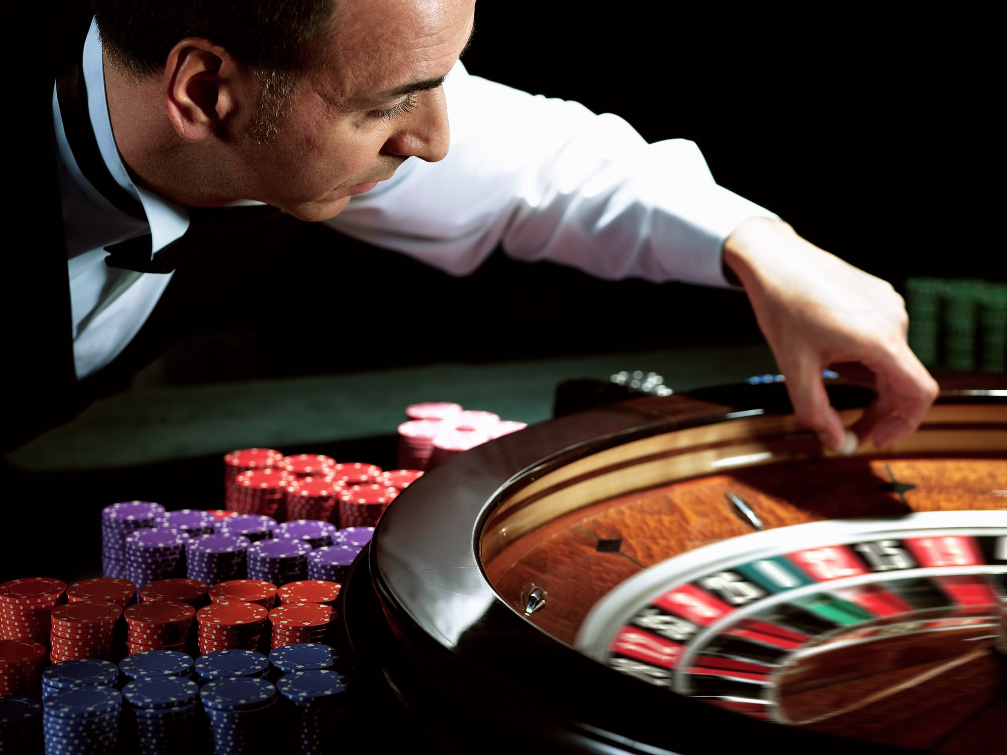 Casino gambling roulette croupier betting chips male getty