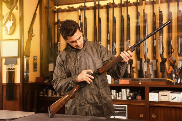 Shopper holding rifle