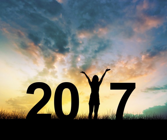 "2017" against a sunset, with a person as the "1"