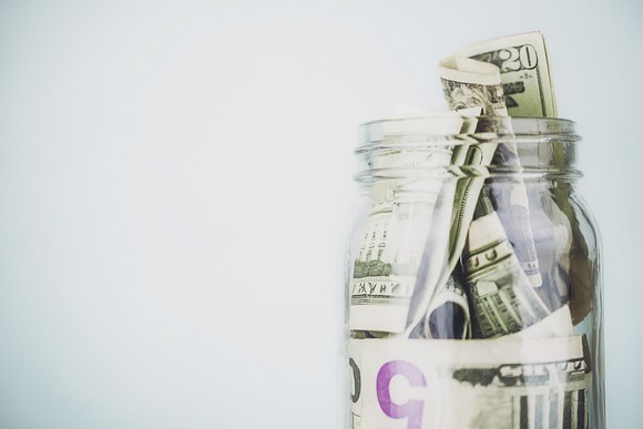U.S. paper currency in a glass jar
