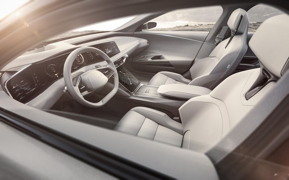 Interior of sedan, showing front seats and dashboard.