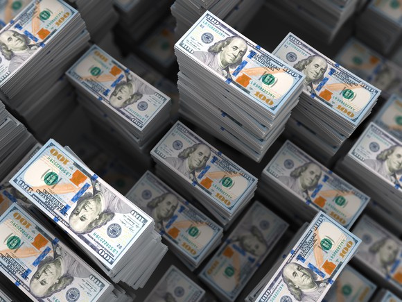 Different sized stacks of 100 dollar bills