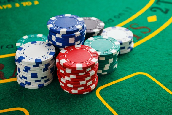 Stacks of poker chips on green felt table