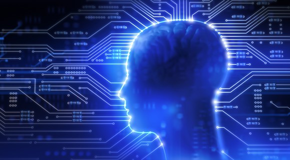 Illuminated profile of human head with brain showing through overlaying computer circuitry.