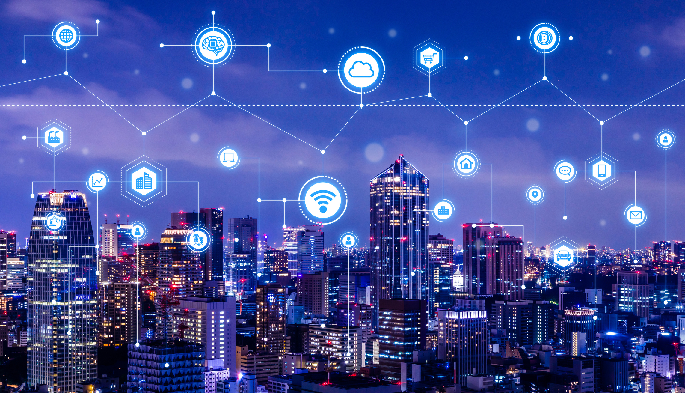 Cityscape at night with a web of various internet-connected icons