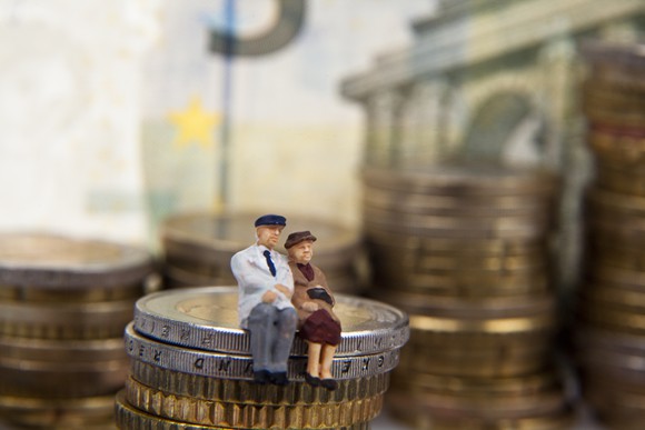 Couple sitting on coin stack
