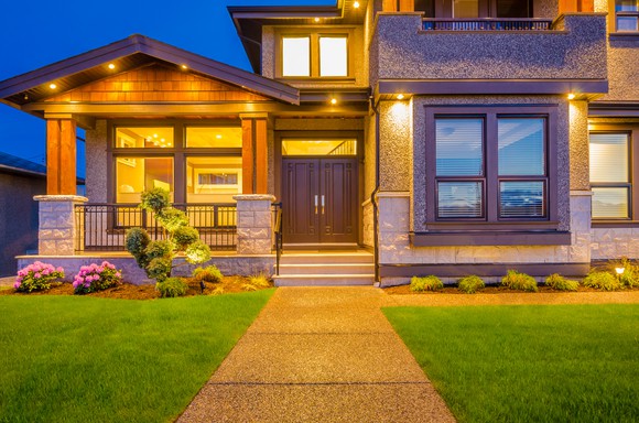 The front of a well-lit, many-windowed house