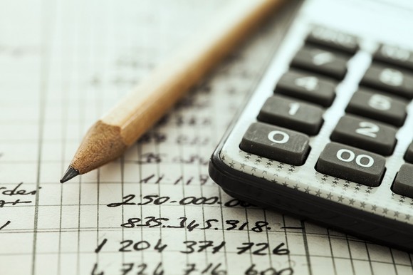 photo of pencil laying next to calculator