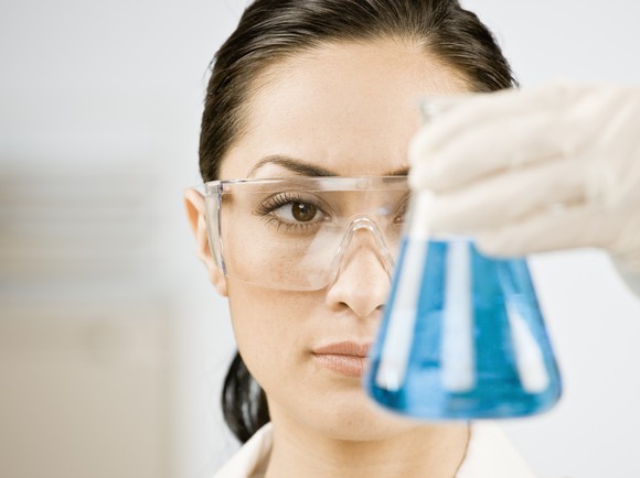 Scientist holding a beaker.