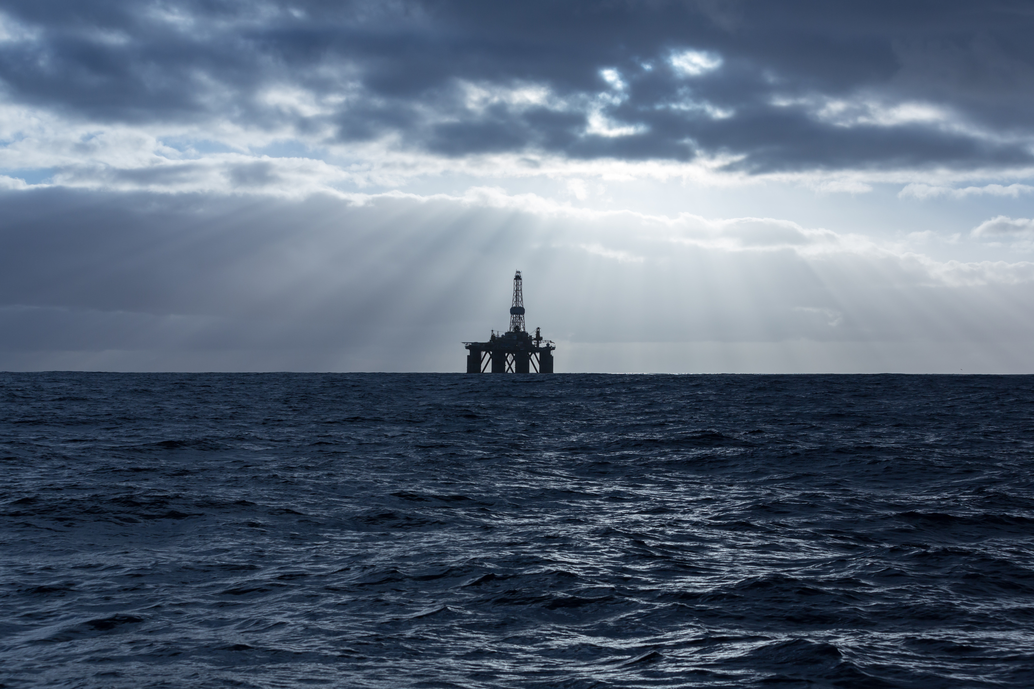 Offshore drilling rig in the middle of a storm.