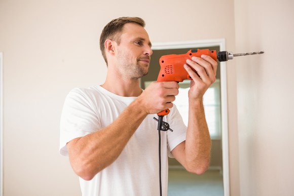 Man using power drill.