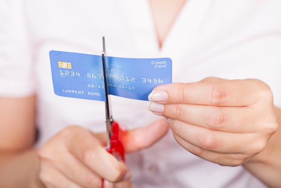 Woman cutting up a credit card.