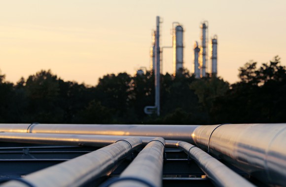 Pipelines to a refinery at dusk.