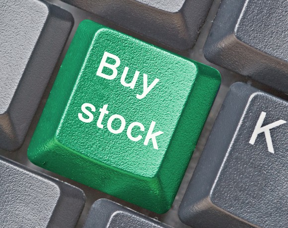 Green "buy" stock button on computer keyboard