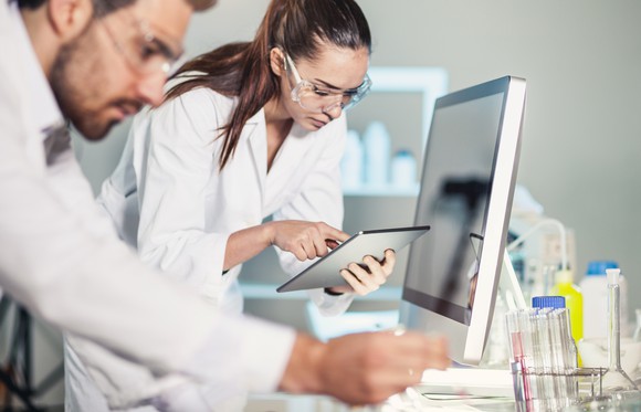 Two medical professionals working on their computers.