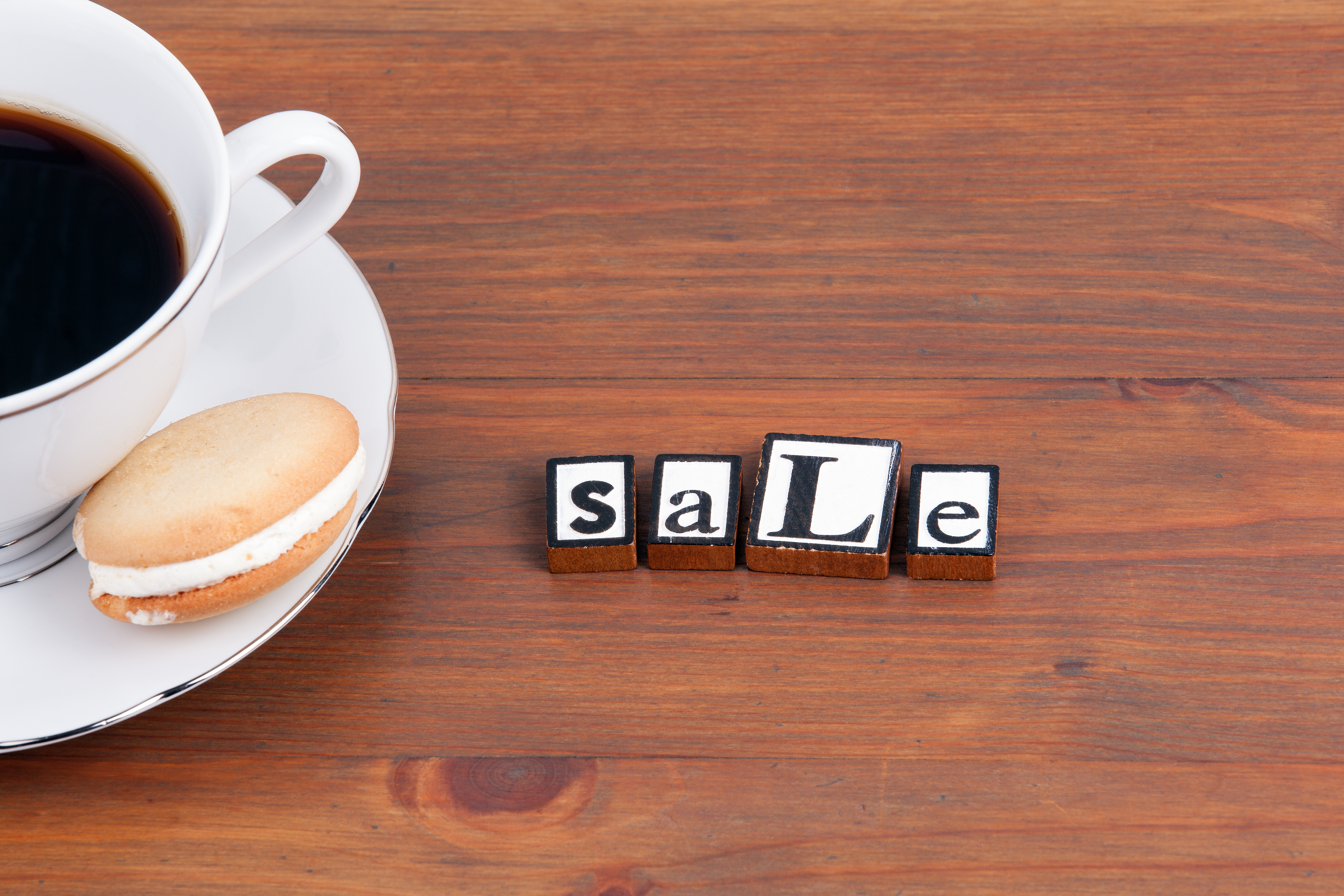 word "sale" next to cup of coffee