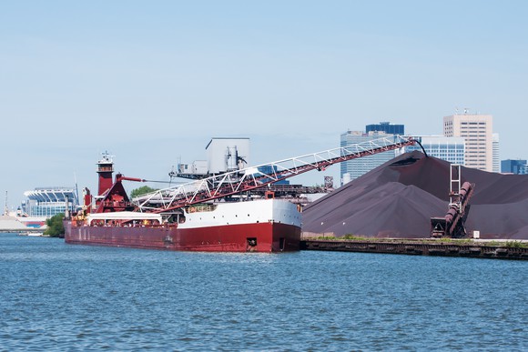 Ship unloading iron ore cargo.