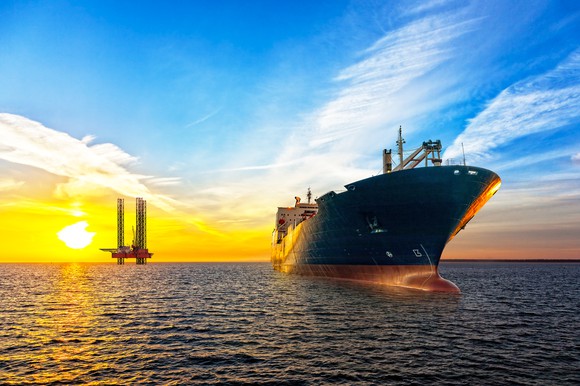 Oil tanker at sea at sunset.