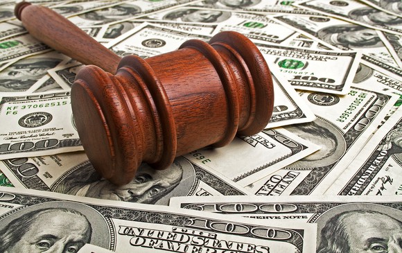 A gavel rests upon a pile of money.