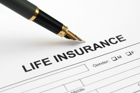 Life insurance paperwork with pen.