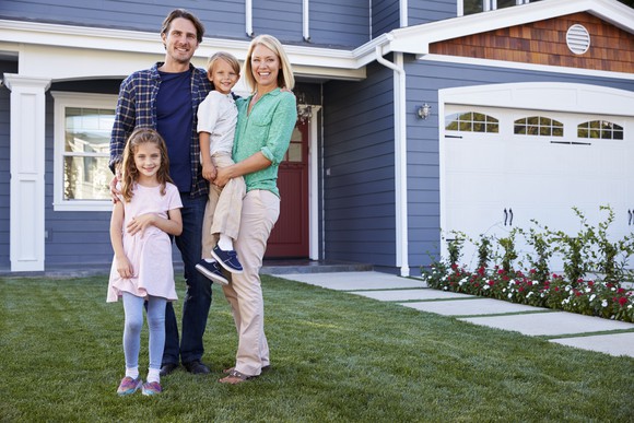 Family standing outside their new home