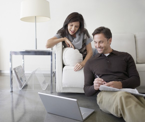 Couple looking at a laptop.