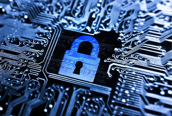 Concept of cybersecurity visualized as a lock inside computer circuitry