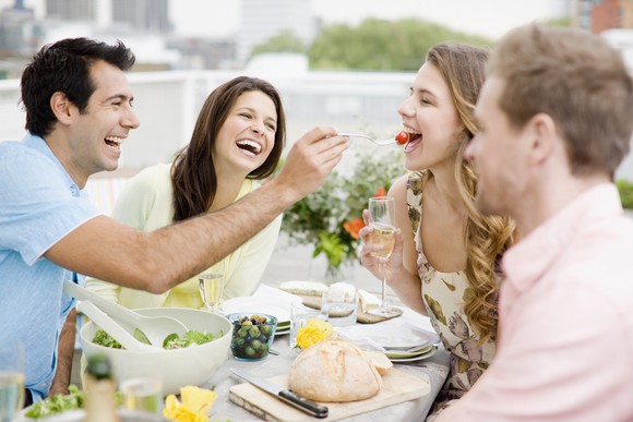 Group of 30-somethings dining and laughing