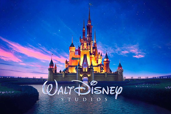 The iconic Walt Disney castle surrounded by a pink and blue sky.