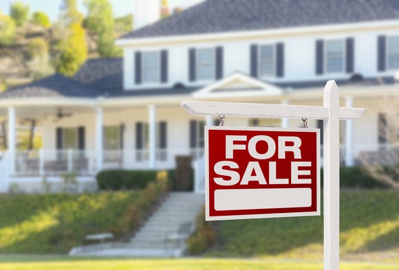 House with a for sale sign out front