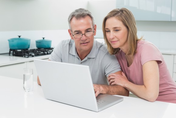 Couple looking at laptop computer.