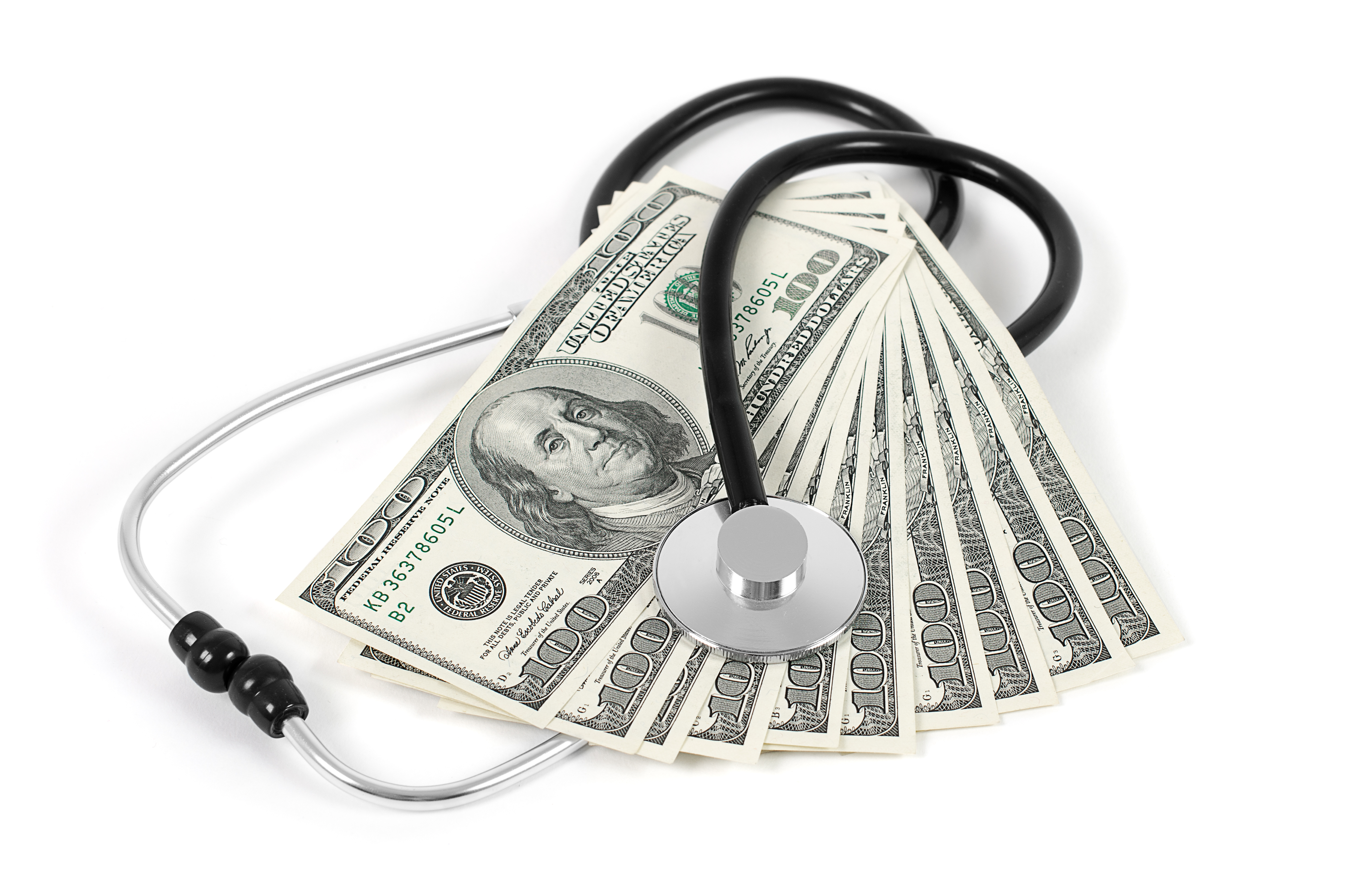 stethoscope on top of fan of bills