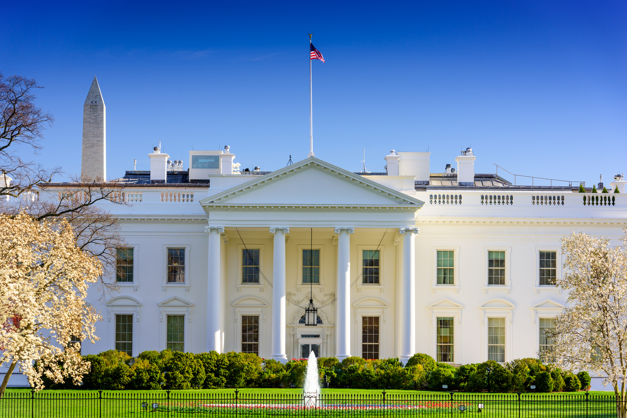 White House with Washington Monument in background.