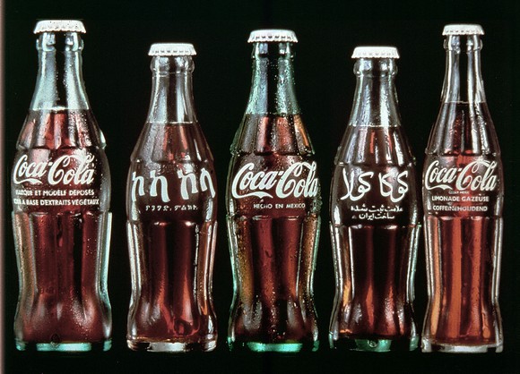 Coca-Cola bottles from around the world with labels in different languages.