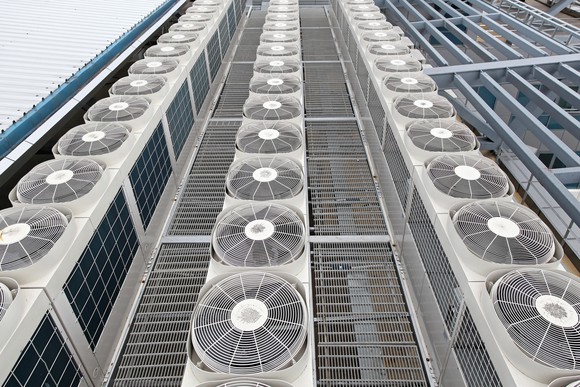 Rows of multiple air conditioning units on top of a building