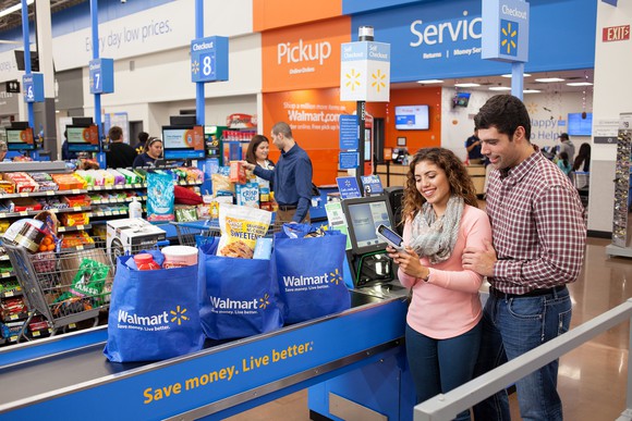 A couple using a self-checkout lane at a Wal-Mart supercenter.