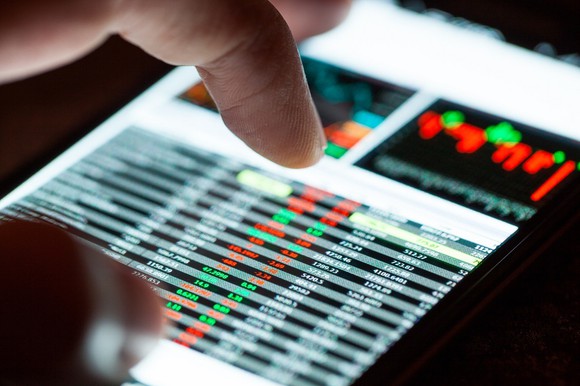 Person placing trades on a cell phone.