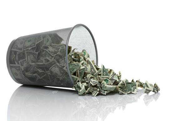 Wire trash can spilling money.